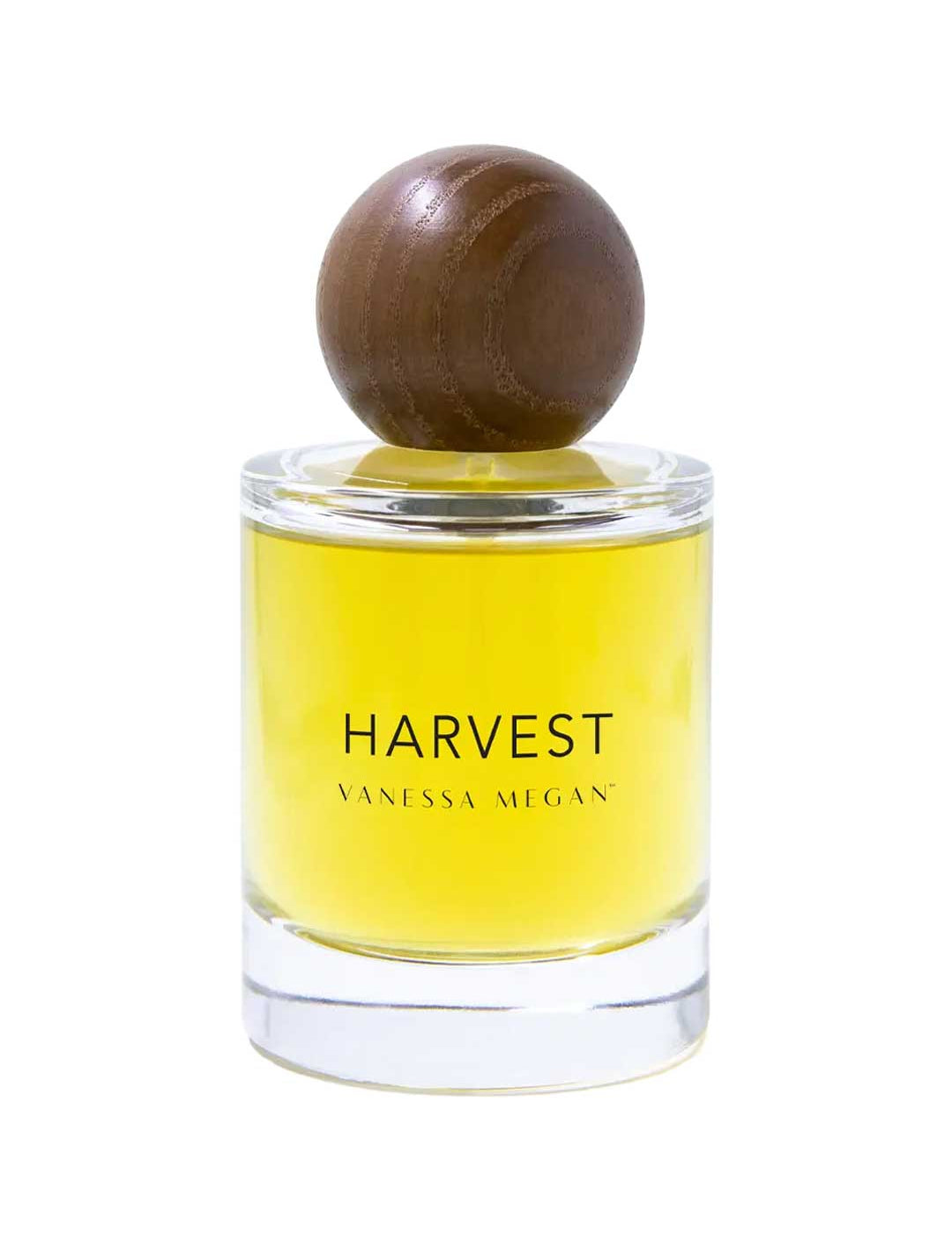 A clear glass bottle with yellow liquid, labeled Vanessa Megan Harvest 100% Natural Eau de Parfum 50ml, features a large round wooden cap—an elegant, natural fragrance from Vanessa Megan.