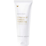 A white 180ml tube of Vanessa Megan Hibiscus & Banksia Mattifying Cream Clay Mask with minimalist gold and grey text and a gold butterfly icon—an ideal purifying treatment for oily and combination skin.