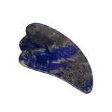 The Vanessa Megan Lapis Lazuli Gua Sha Massage Tool, featuring a blue and gold marbled design with a curved, ridged edge for lymphatic drainage, is displayed against a white background.