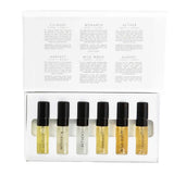 The Vanessa Megan 100% Natural Mini Eau de Parfum Collection (6 x 3ml) features six labeled vials with black caps in a white box. The inside lid lists scent descriptions, including a natural white-floral fragrance. All vials are neatly arranged in a row.