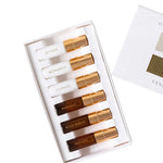 The Vanessa Megan Mini Natural Perfume Collection 6 x 3ml features six elegant plant-based scents—Aether, Monarch, Liliquoi, Harvest, Wild Woud, and August—in a white box with a gold-accented lid partially visible in the upper right corner.