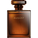A square amber glass bottle with a matching cap, labeled VANESSA MEGAN AUGÜST 50ml e 1.7FL OZ in gold on the front, holds Vanessa Megan Augüst 100% Natural Perfume, an Australian sandalwood fragrance.