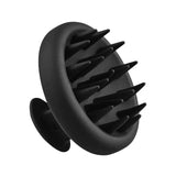 The Vanessa Megan Scalp Massager features black silicone bristles, a round handle, and multiple flexible tips in a circular pattern—ideal for shower use to support healthy hair.