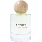 A clear glass bottle labeled Vanessa Megan Aether 100% Natural Eau de Parfum 50ml, with light yellow perfume and a round light wood cap, handcrafted in Australia, sits against a white background.