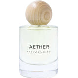 A clear glass bottle labeled Vanessa Megan Aether 100% Natural Eau de Parfum 50ml, with light yellow perfume and a round light wood cap, handcrafted in Australia, sits against a white background.