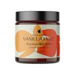 A 60ml jar of Vanilla Mozi Organic Precious Skin Balm, made in Australia with spearmint and vanilla, features a minimalist cream label with abstract orange and red leaves.