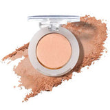 The 100% Pure Fruit Pigmented® Eye Shadow 2g by 100% Pure is a round beige pressed powder compact with a clear lid, displayed open on a smear of powder—ideal for those seeking vegan pressed eyeshadow.