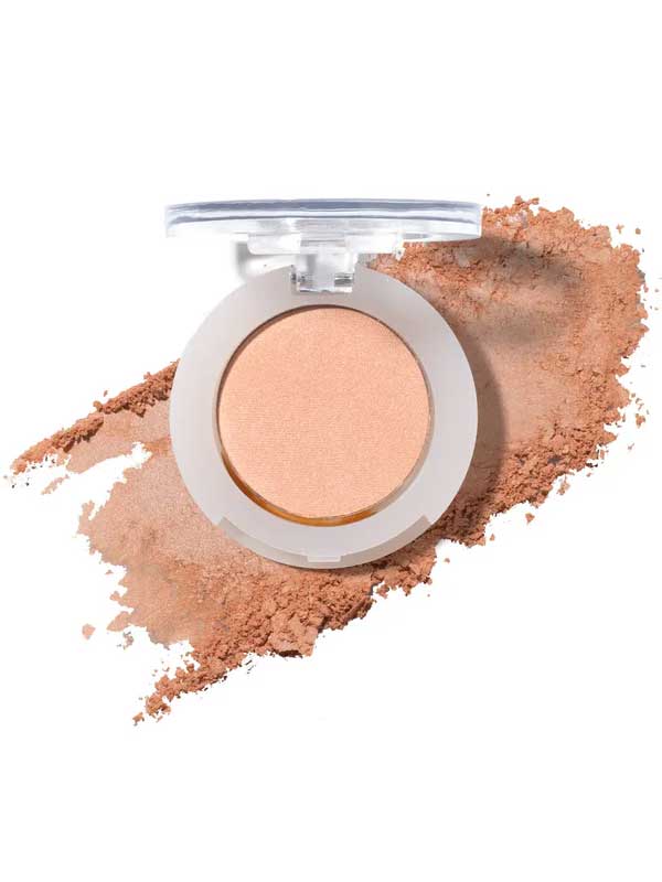 The 100% Pure Fruit Pigmented® Eye Shadow 2g by 100% Pure is a round beige pressed powder compact with a clear lid, displayed open on a smear of powder—ideal for those seeking vegan pressed eyeshadow.