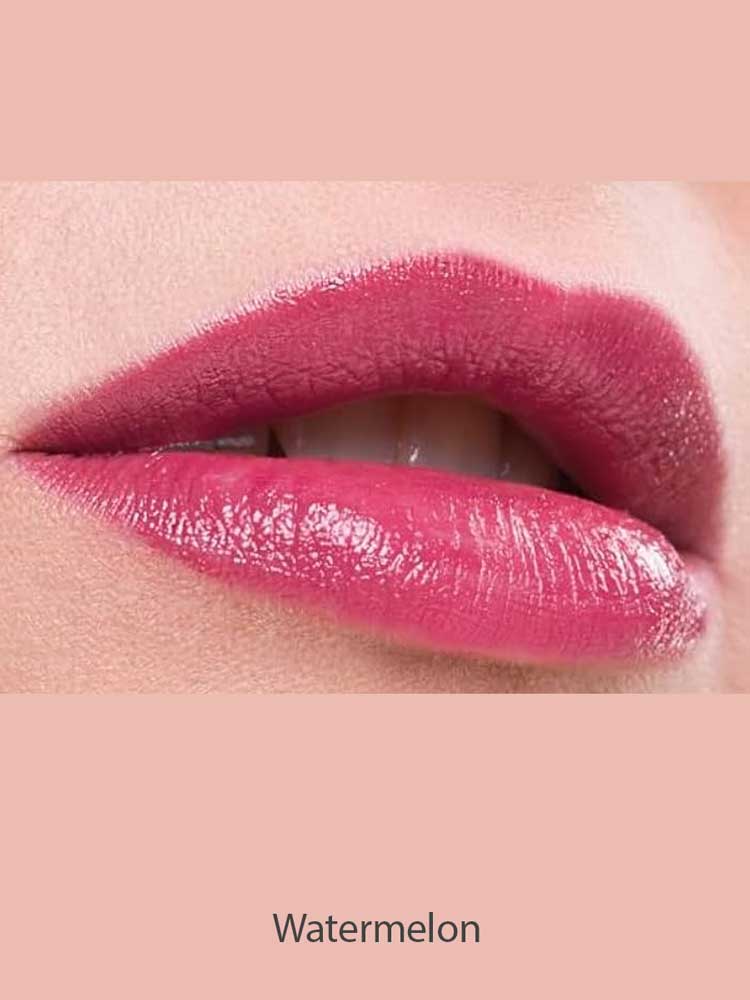 Close-up of lips wearing glossy, pigmented pink Benecos Natural Lipsticks 4.5g, slightly parted to reveal white teeth. The background matches the lipstick shade with "Watermelon" written below the image.
