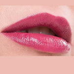 Close-up of lips wearing glossy, pigmented pink Benecos Natural Lipsticks 4.5g, slightly parted to reveal white teeth. The background matches the lipstick shade with "Watermelon" written below the image.