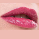 Close-up of lips wearing glossy, pigmented pink Benecos Natural Lipsticks 4.5g, slightly parted to reveal white teeth. The background matches the lipstick shade with "Watermelon" written below the image.