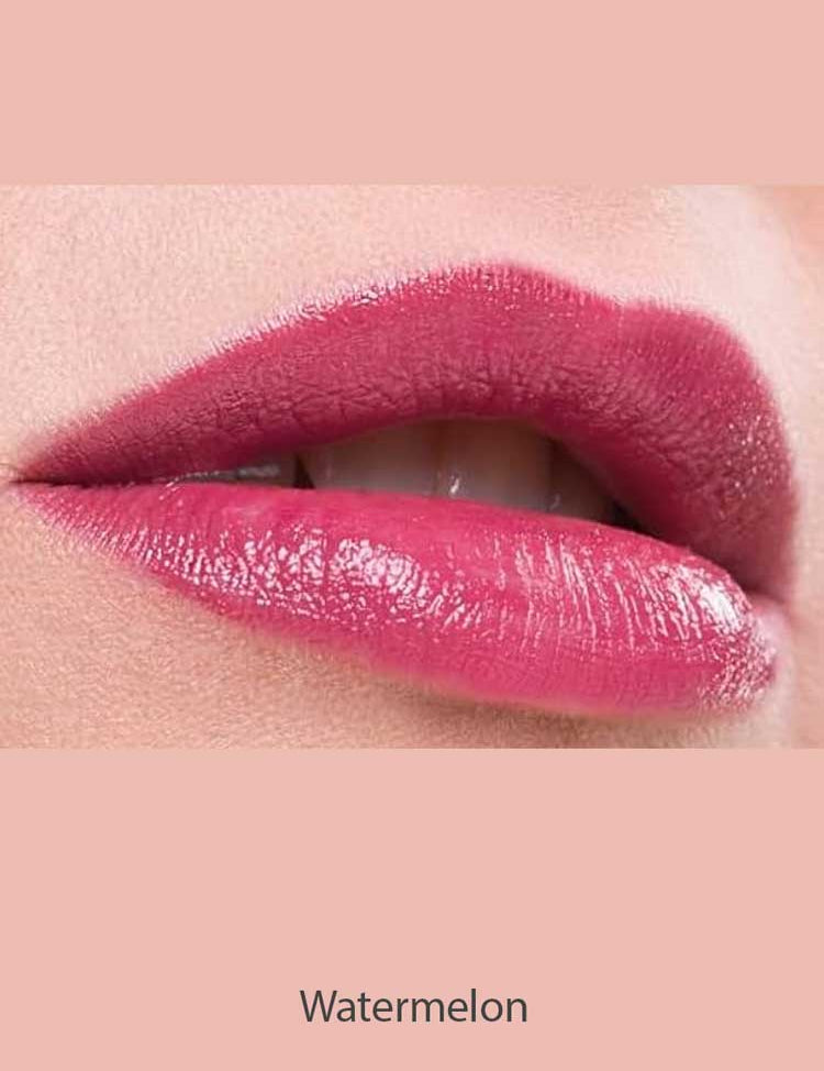 Close-up of lips wearing glossy, pigmented pink Benecos Natural Lipsticks 4.5g, slightly parted to reveal white teeth. The background matches the lipstick shade with "Watermelon" written below the image.