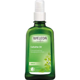 A green glass bottle of Weleda Birch Cellulite Oil 100ml with a white pump dispenser. The label displays the brand name, product name, and an illustration of birch leaves.