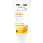 White Weleda Calendula Toothpaste tube with a yellow band marked Fennel Flavour, an orange flower illustration and a white cap.
