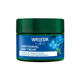 A jar of Weleda Contouring Day Cream Blue Gentian & Edelweiss with a dark green lid and blue label featuring blue flowers. The label highlights Blue Gentian extract to reduce deep wrinkles and balance skin pigmentation.