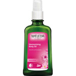 Weleda Harmonising Wild Rose Body Oil 100ml comes in a green bottle with a white pump and pink label adorned with wild rose flowers—ideal for anyone seeking nourishing, natural body oil.
