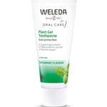White Weleda Plant Gel Toothpaste tube with a white ribbed cap, a green band marked Spearmint Flavour and mint leaf illustrations.