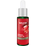 A green glass bottle of Weleda Pomegranate Firming Facial Oil 30ml with a white dropper cap and red label featuring a pomegranate image, highlighting pomegranate seed oil for reducing lines and nourishing mature skin.