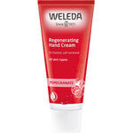 A red tube of Weleda Pomegranate Regenerating Hand Cream 50ml for all skin types, featuring the brand logo, product name, and pomegranate seeds— a natural vegan hand cream for nourished skin.
