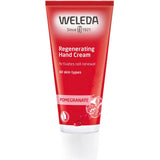 A red tube of Weleda Pomegranate Regenerating Hand Cream 50ml for all skin types, featuring the brand logo, product name, and pomegranate seeds— a natural vegan hand cream for nourished skin.