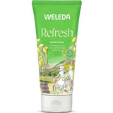A green 200 ml tube of Weleda Refresh Citrus Body Wash, a natural cleanser with a citrus scent. The packaging shows cyclists in the countryside with lemons and lavender, emphasizing its refreshment from lemon oil.
