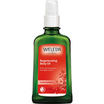 A green glass bottle of Weleda Regenerating Body Oil Pomegranate 100ml features a white pump top and red label with pomegranate imagery, offering product details for enhanced skin firmness.