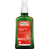 A green glass bottle of Weleda Regenerating Body Oil Pomegranate 100ml features a white pump top and red label with pomegranate imagery, offering product details for enhanced skin firmness.