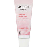 A pink and white 50ml tube of Weleda Sensitive Hand Cream Fragrance Free for sensitive skin, featuring the Weleda logo, a feather graphic, and text highlighting soothing and moisturizing benefits.