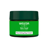 A green jar labeled Weleda Skin Food Face Care Nourishing Day Cream 40ml with a dark green lid is displayed against a white background, highlighting this hydrating face moisturizer.