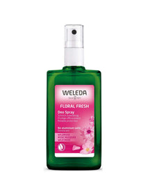 A green bottle of Weleda Floral Fresh Deodorant Spray - Wild Rose 100ml has a pink floral label noting its natural, aluminium-free formula.