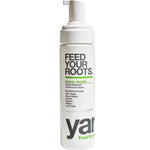A white pump bottle of Feed Your Roots. volume enhancer with black and green text, on a solid white background.