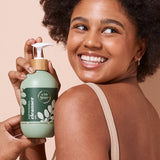 A bit Hippy Face and Body Cleanser held by a smiling woman