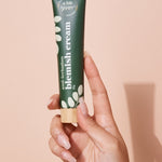 A bit Hippy Blemish Cream tube held in hand