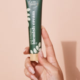 A bit Hippy Blemish Cream tube held in hand
