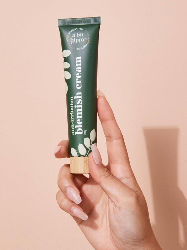 A bit Hippy Blemish Cream tube held in hand