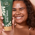 A bit Hippy Body Lotion held by a smiling woman