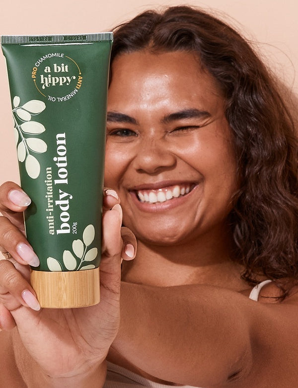 A bit Hippy Body Lotion held by a smiling woman