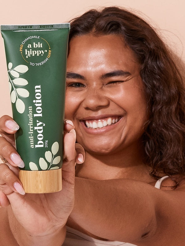A bit Hippy Body Lotion held by a smiling woman