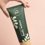 A bit Hippy Body Lotion tube held in hand