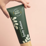 A bit Hippy Body Lotion tube held in hand
