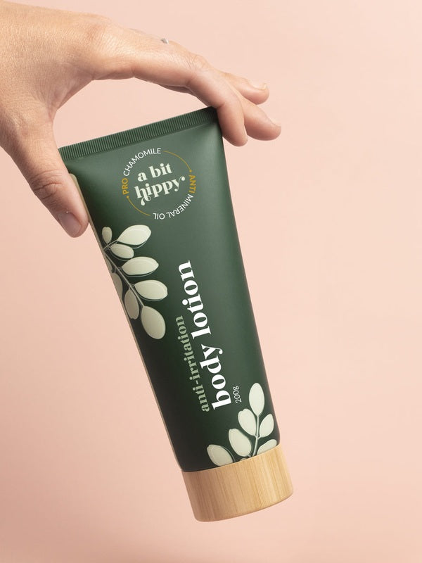 A bit Hippy Body Lotion tube held in hand