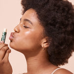 A bit Hippy Coconut and Lime SPF 15 Lip Balm held to the lips