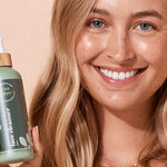 A bit Hippy Face Cleanser held by a smiling woman