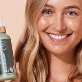 A bit Hippy Face Cleanser held by a smiling woman