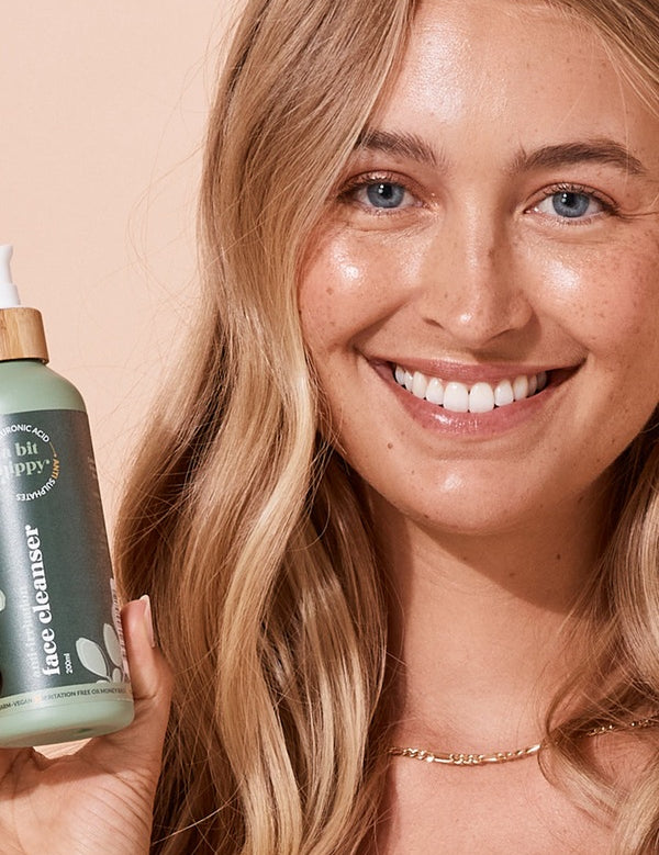 A bit Hippy Face Cleanser held by a smiling woman