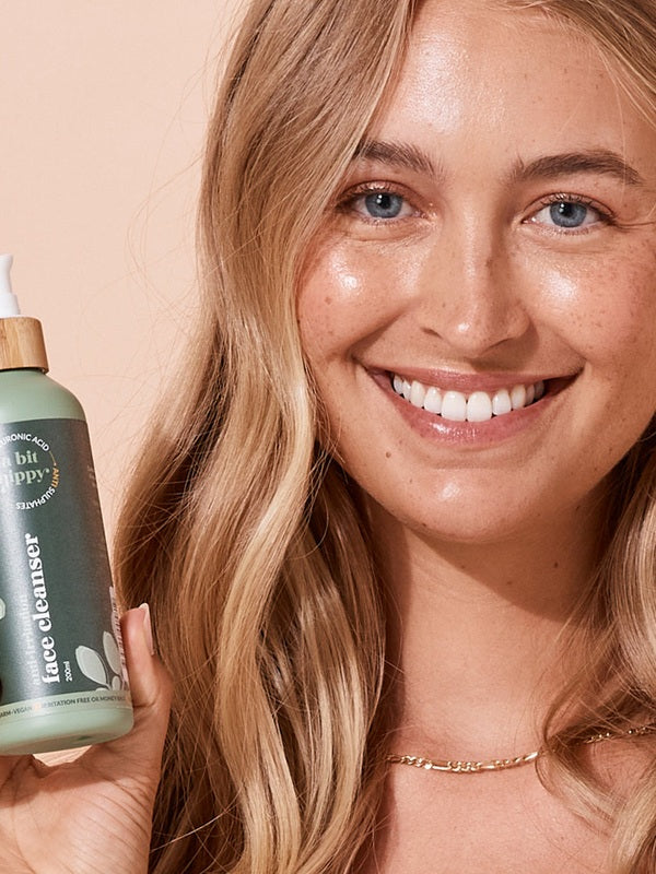 A bit Hippy Face Cleanser held by a smiling woman