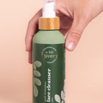 A bit Hippy Face Cleanser bottle held in hand