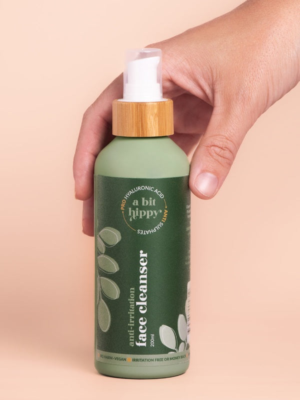 A bit Hippy Face Cleanser bottle held in hand