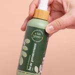 A bit Hippy Heat Protectant Spray held in hand