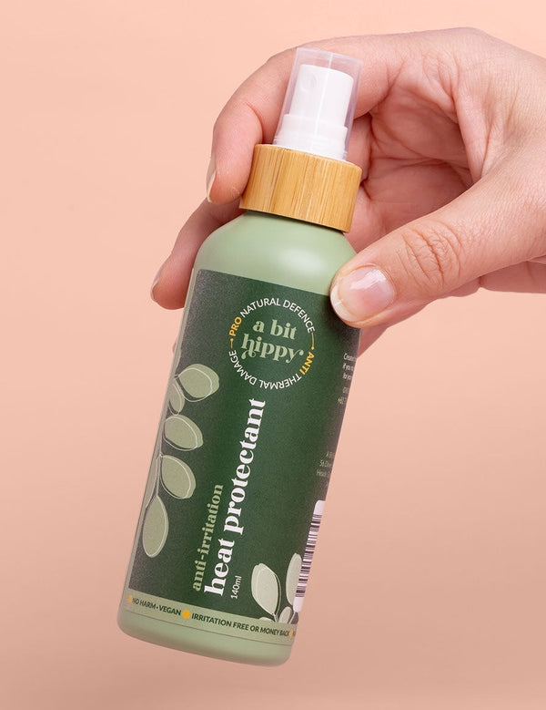A bit Hippy Heat Protectant Spray held in hand